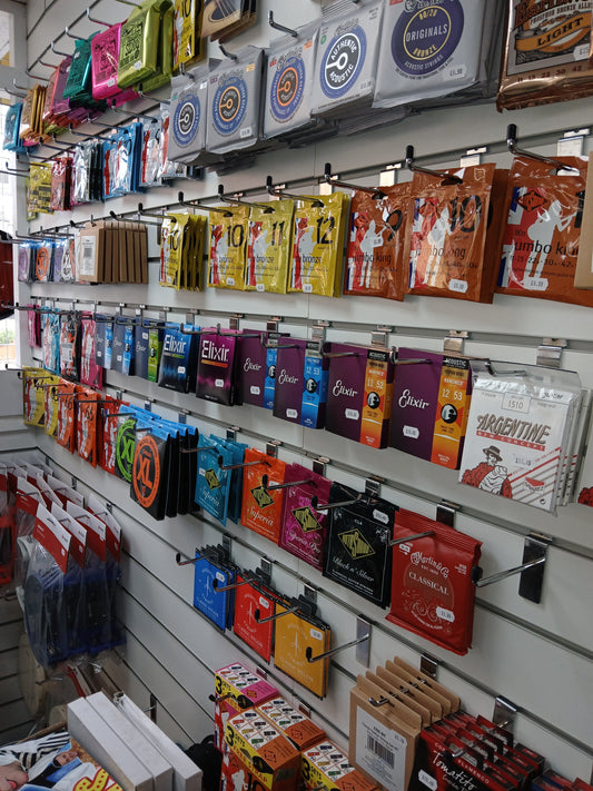 Selection of guitar strings showing different gauges and materials for acoustic and electric guitars